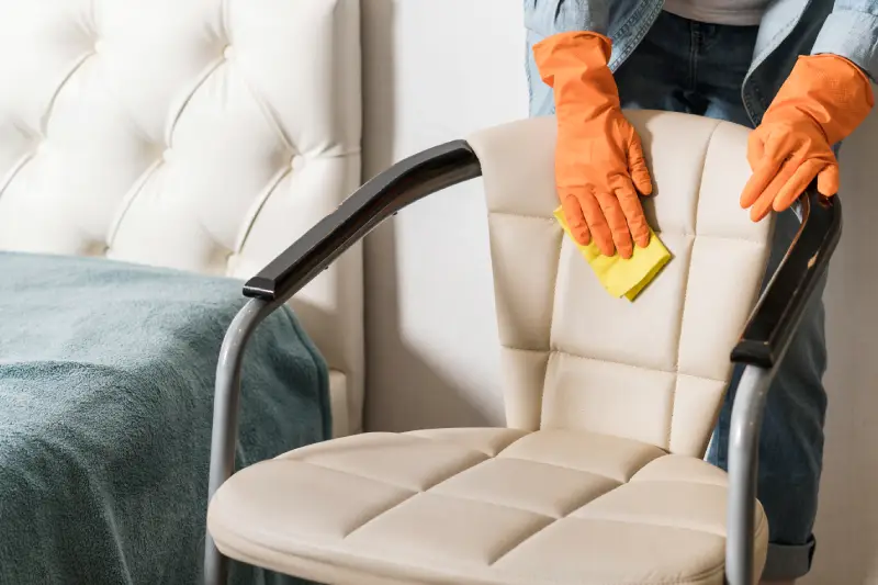 Front view of woman cleaning chair